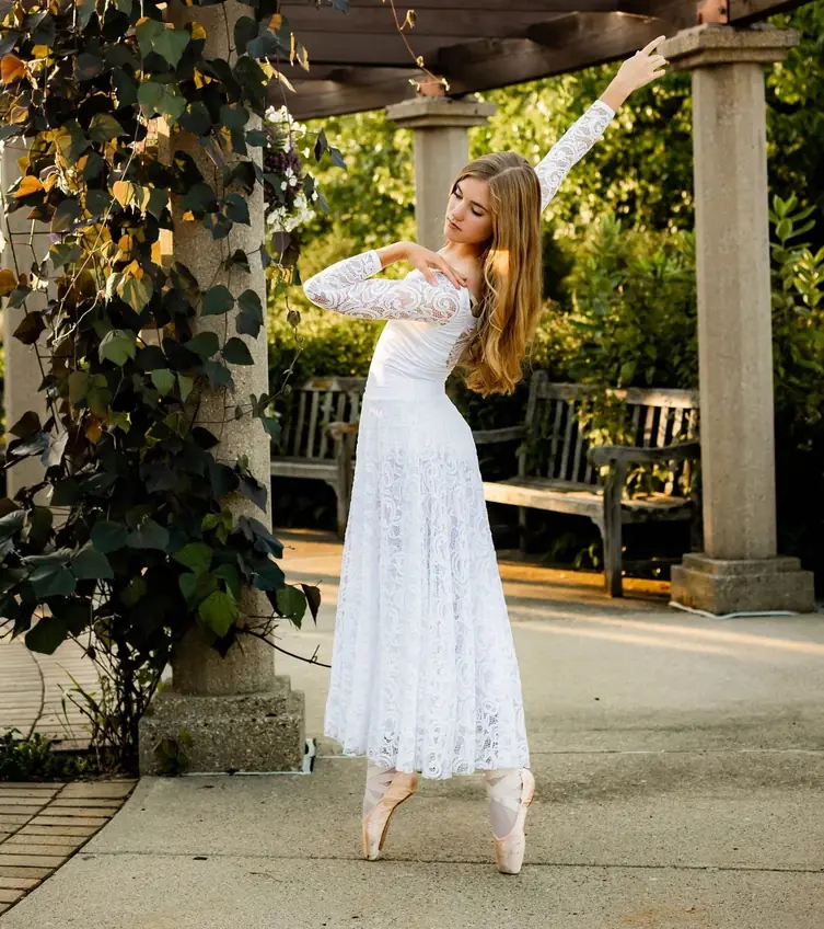 Portrait of Janae Ballah, dance instructor, in a garden pose